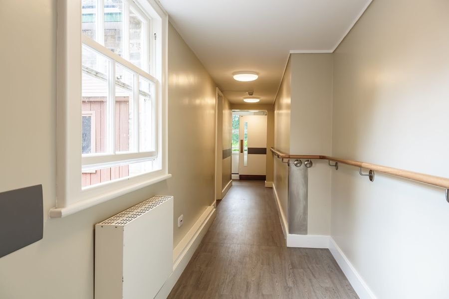 Refurbished corridor with handrail, new flooring and natural light