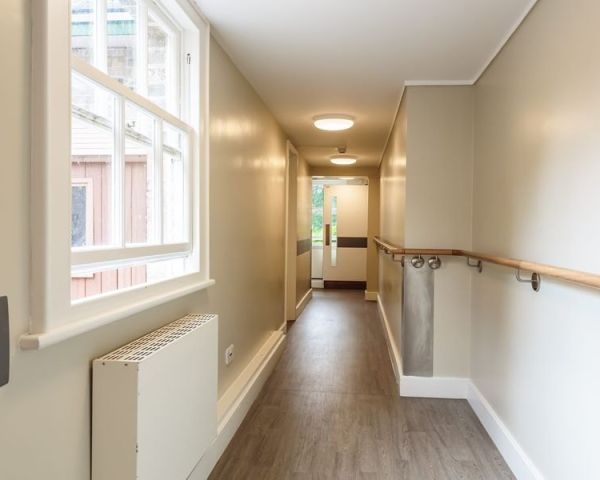 Refurbished corridor with handrail, new flooring and natural light