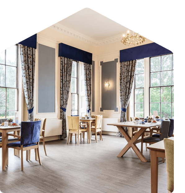 Refurbished communal dining room with tall windows and period detailing